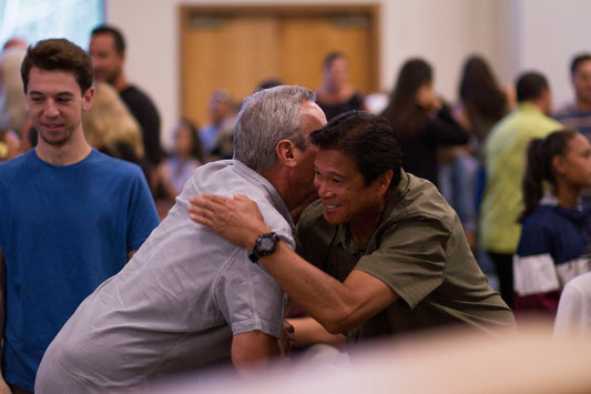 two men embracing at church 
