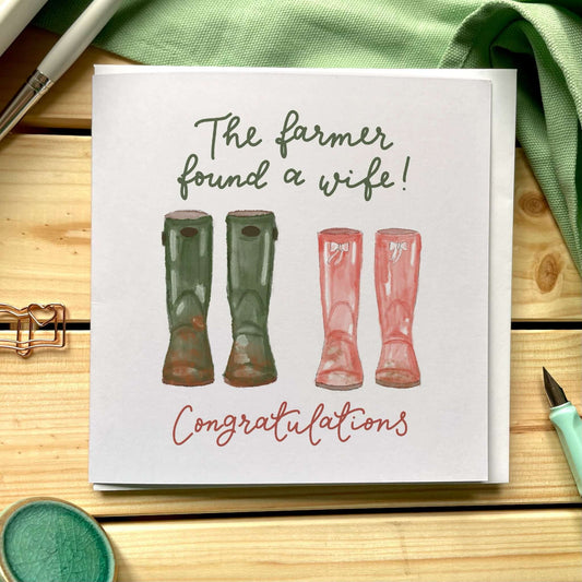 The farmer found a wife wedding card with two sets of wellies and the word congratulations hand lettered