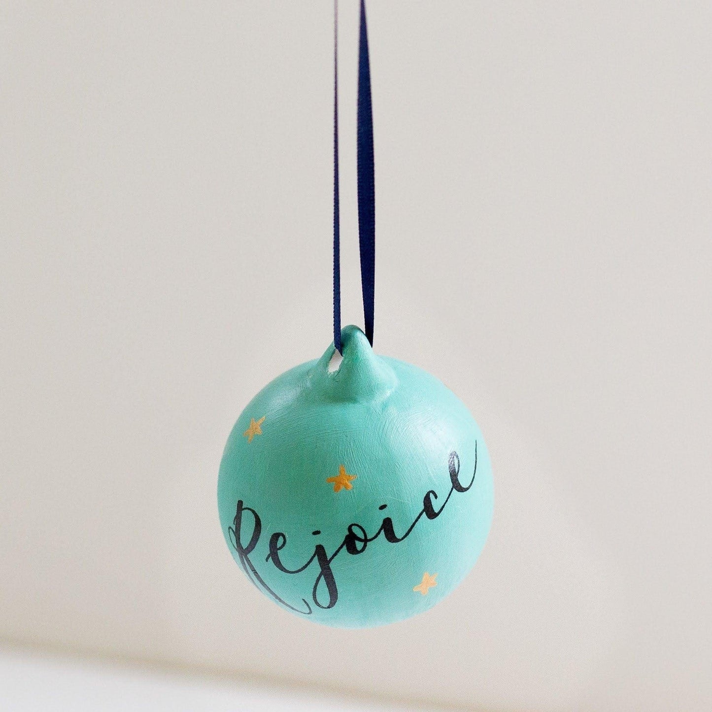 Mint green Christian Christmas decoration with the word rejoice