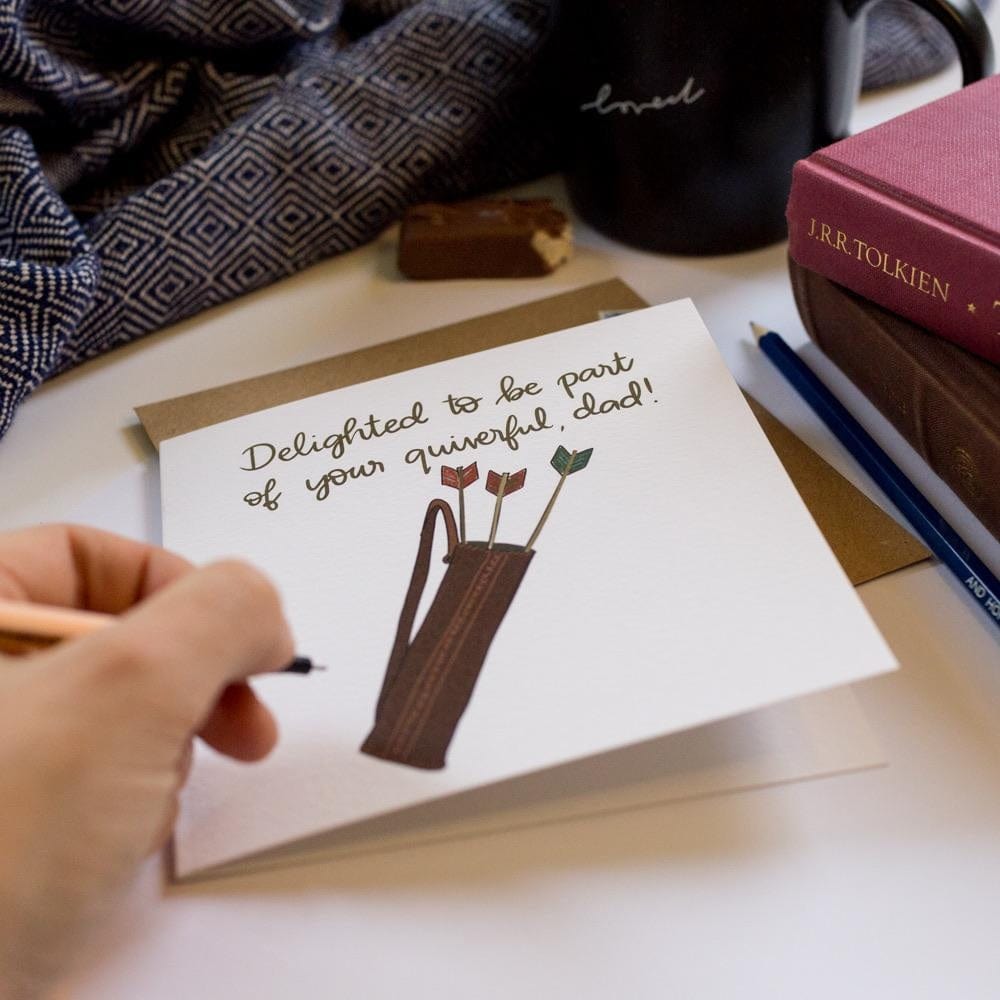 Lifestyle photo of Christian Father’s Day card with a hand holding a pen